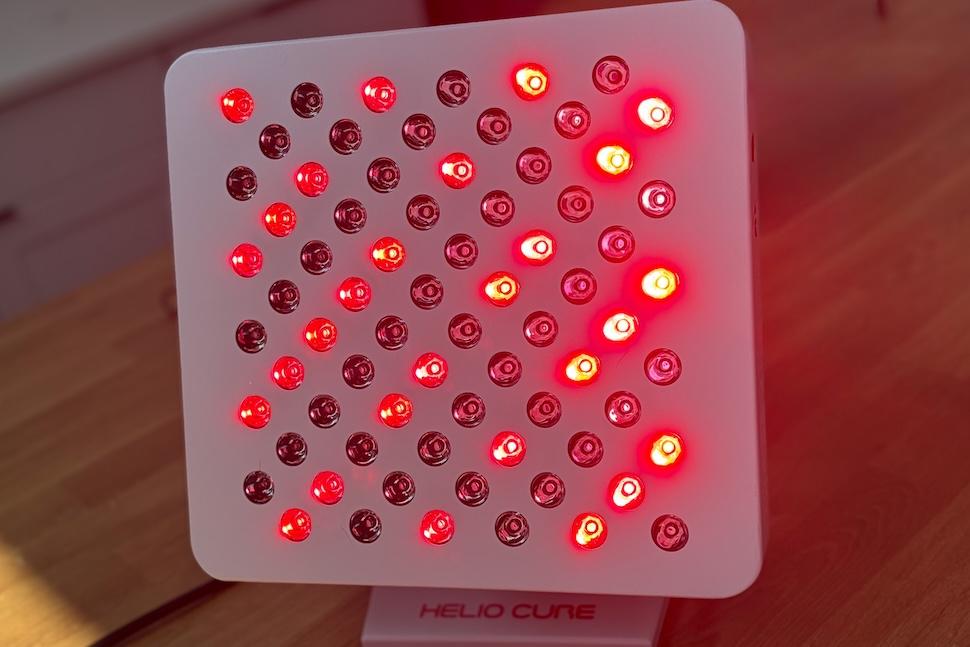 The Helio Spark by Helio Cure red light therapy panel lit up and ready to use