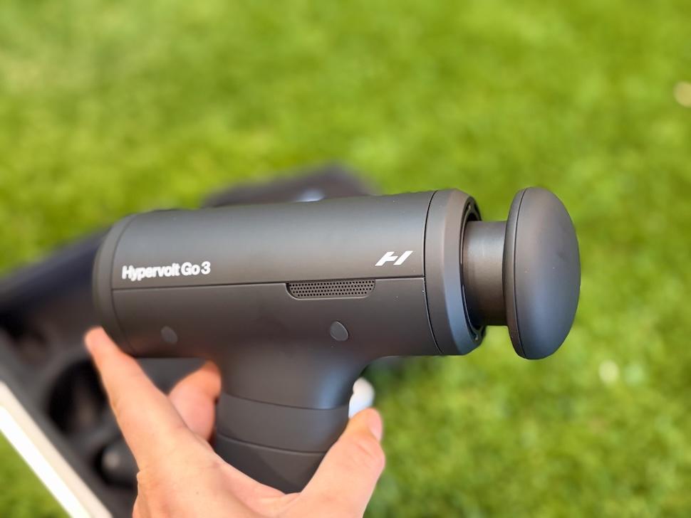 Closeup of a hand holding the Hyperice Hypervolt Go 3 massage gun