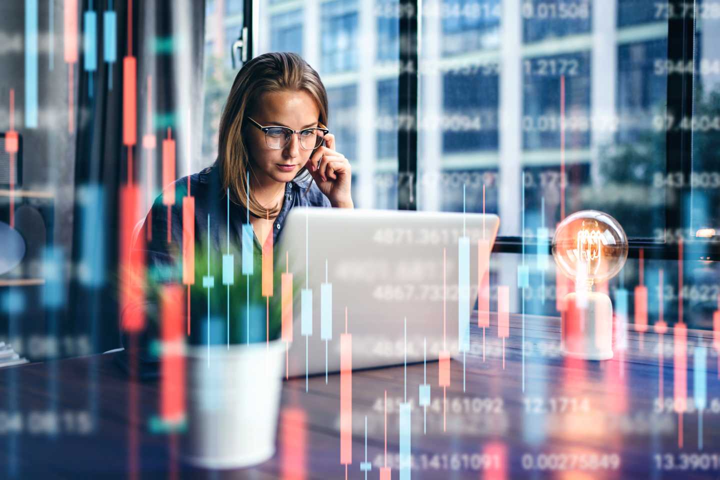 Young woman working at modern office.Technical price graph and indicator, red and green candlestick chart and stock trading computer screen background.