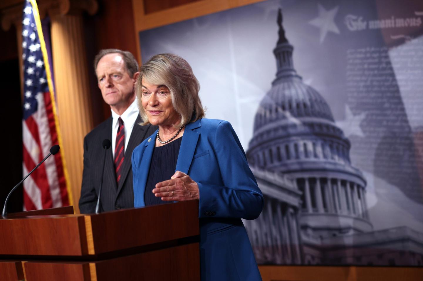 Senator Cynthia Lummis speaks into a microphone on a podium.