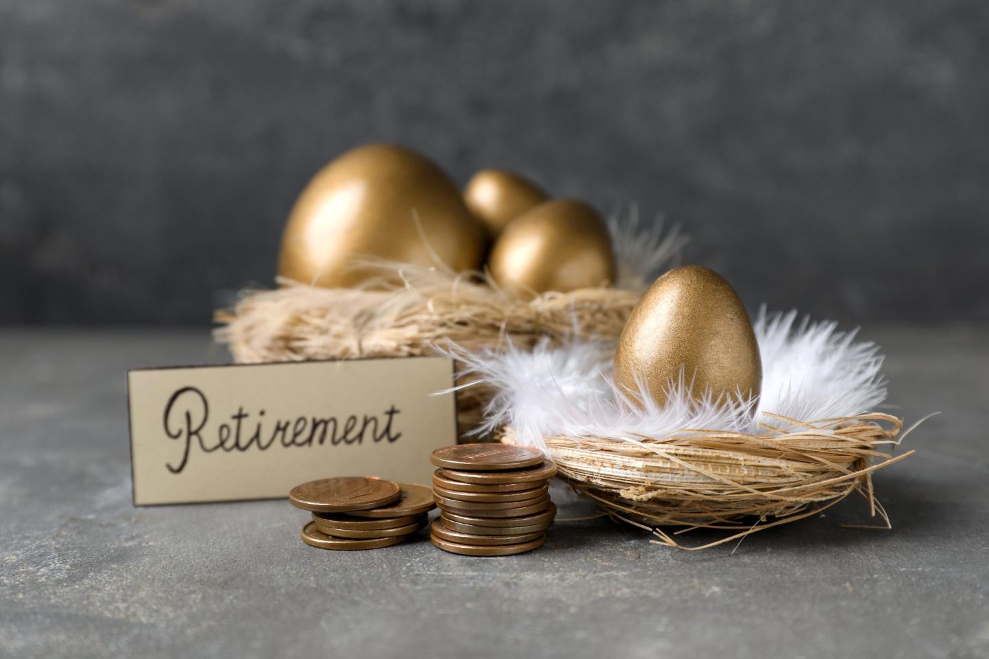 A nest of golden eggs with a sign that says Retirement.