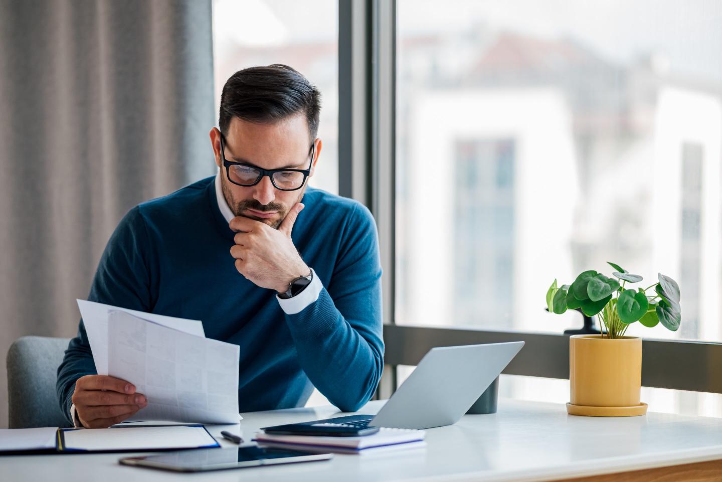 A person reading forms at their desk.