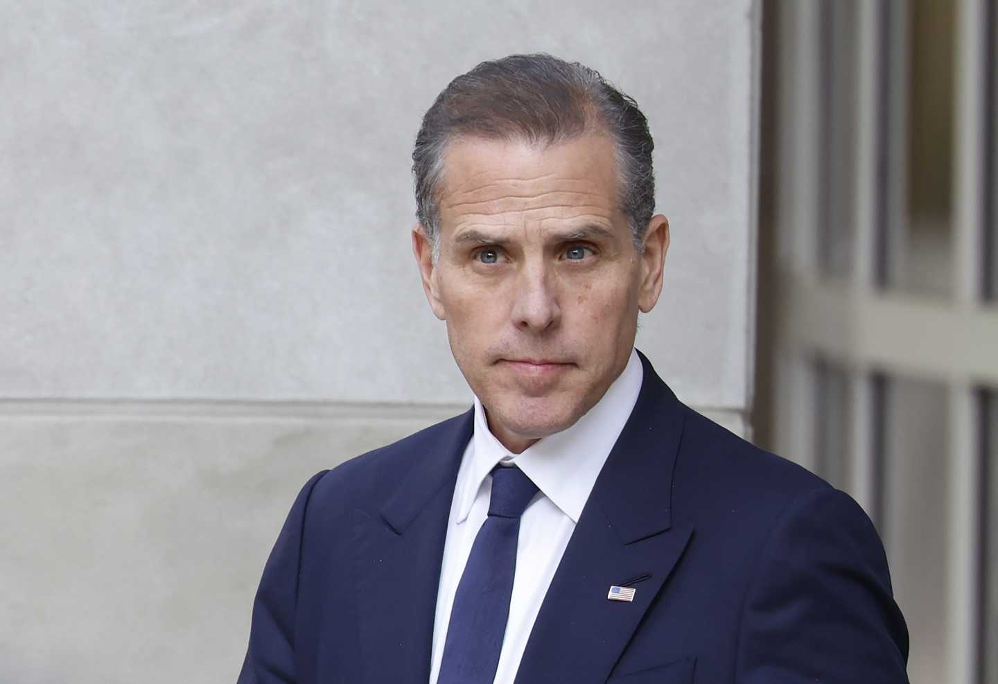 Hunter Biden wears a suit and gazes off into the distance.
