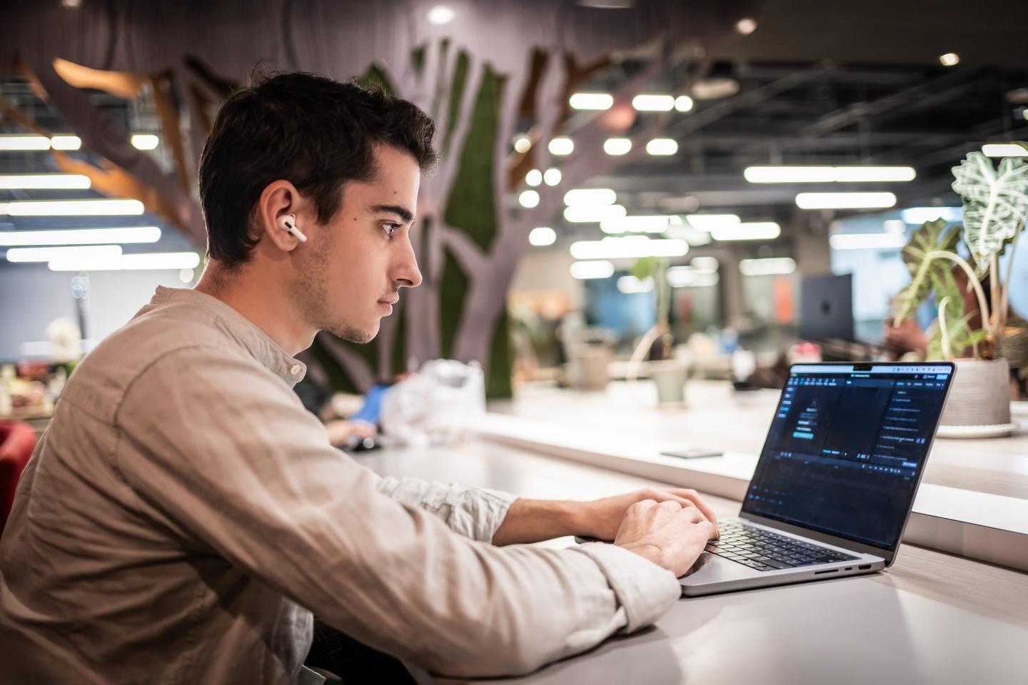 Young worker in an office on a laptop