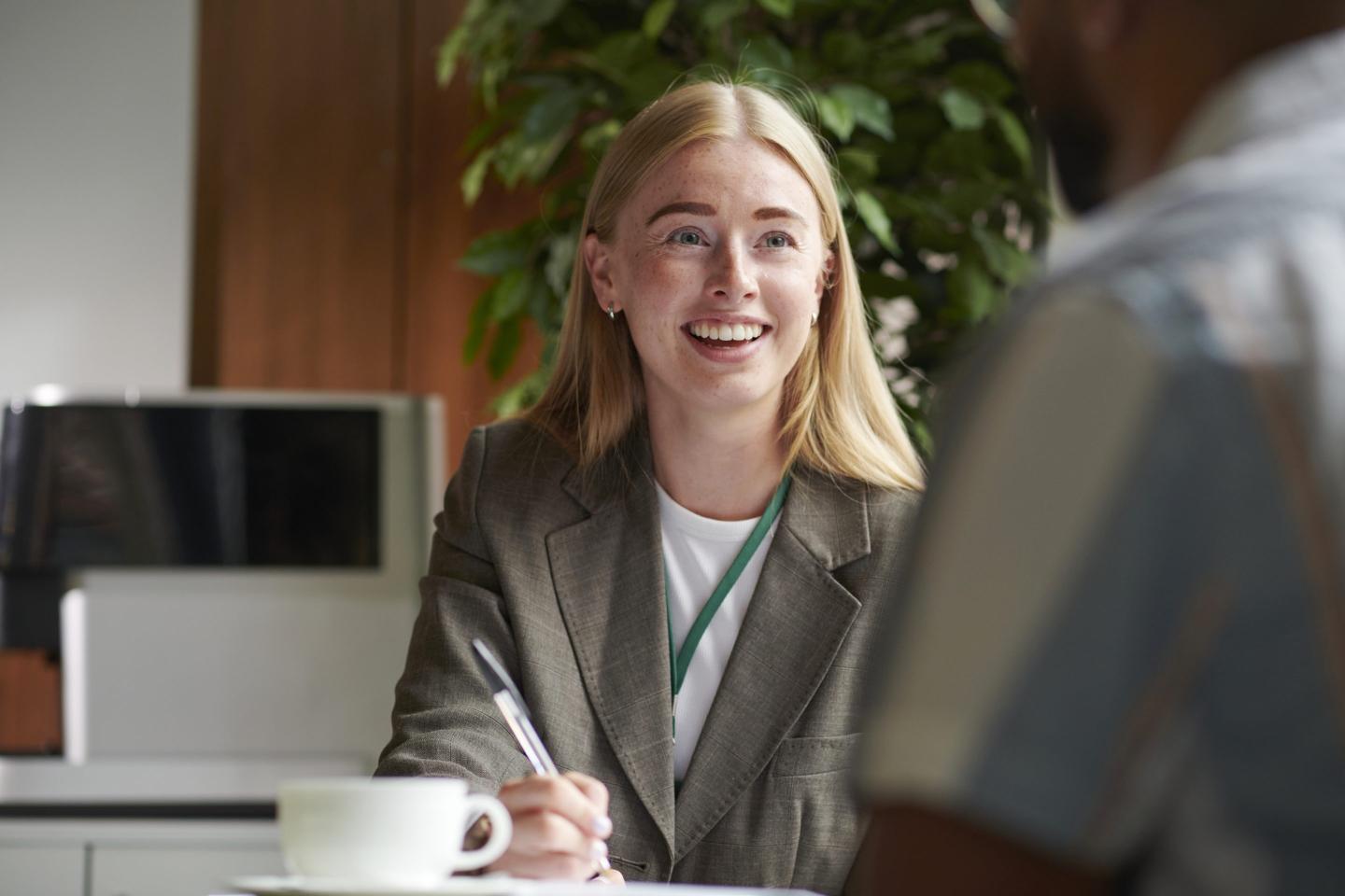 young woman speaking to a client