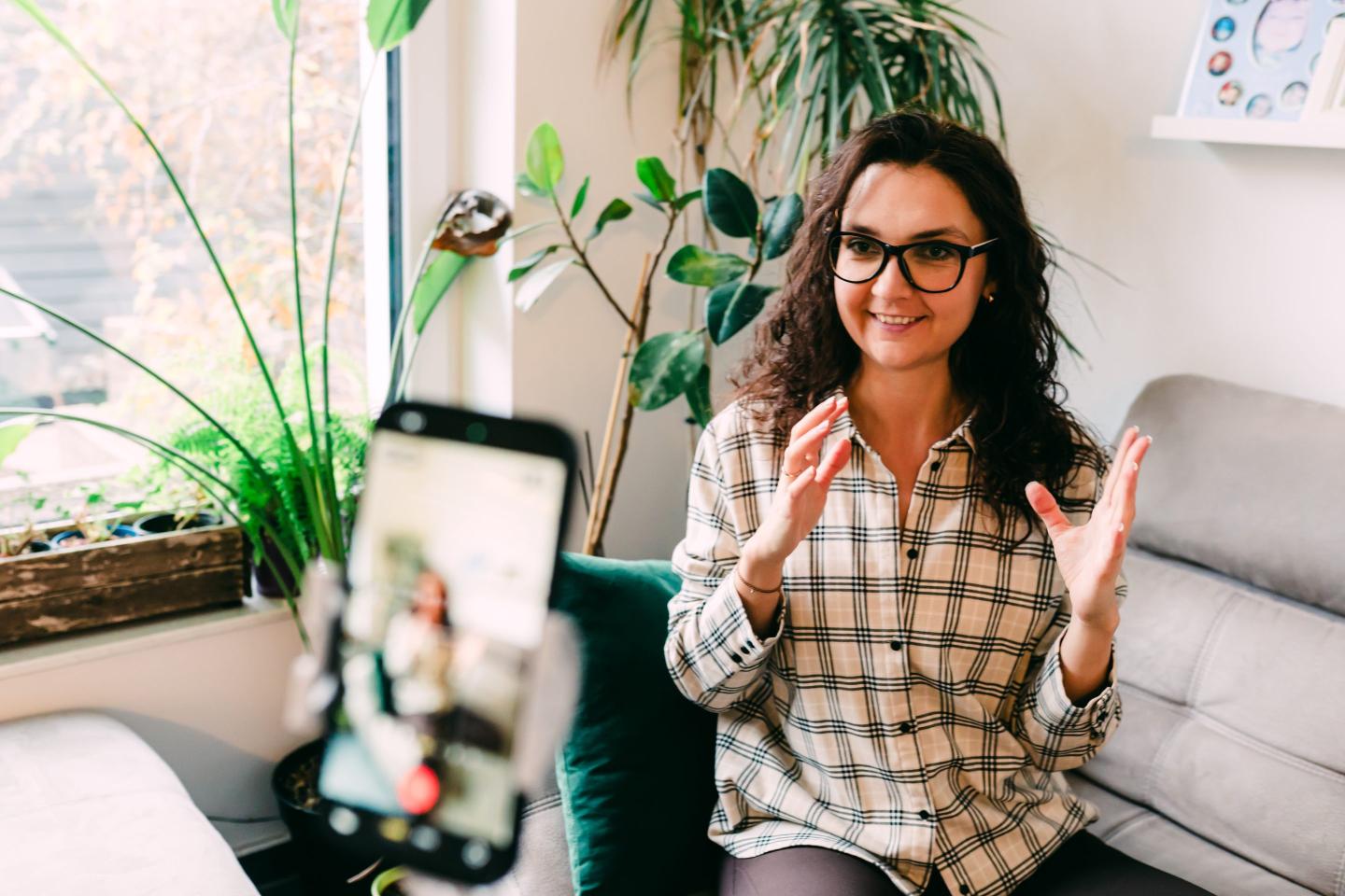 Woman Recording Video on Smartphone at Home