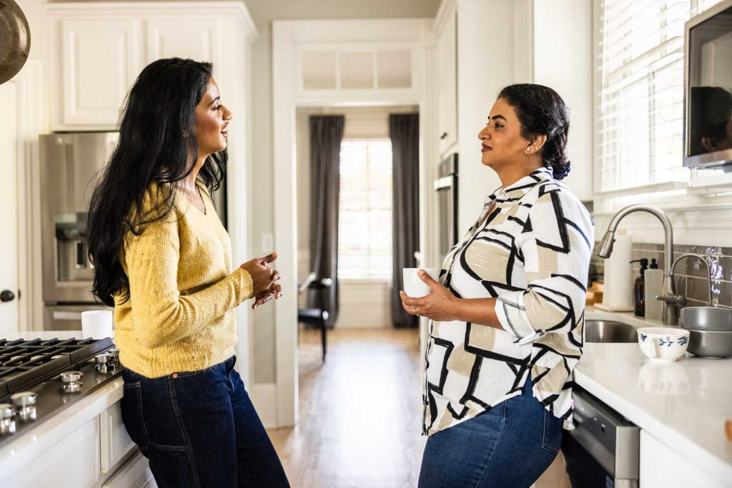 Millennial with mother in family house