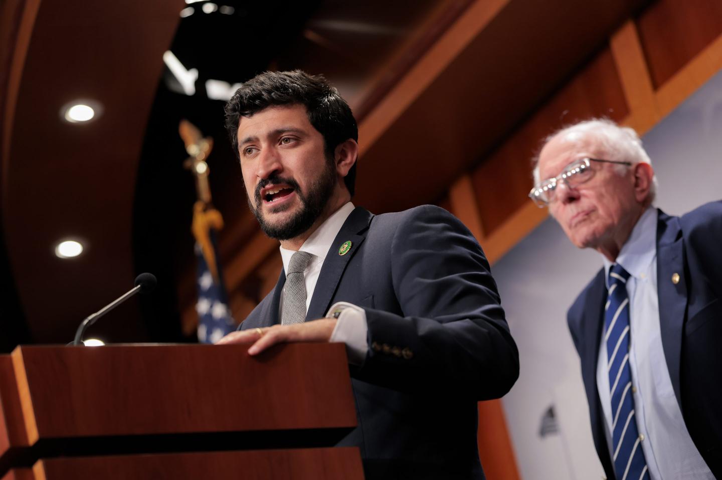 Photo of Rep. Greg Casar talking with Bernie Sanders in the background