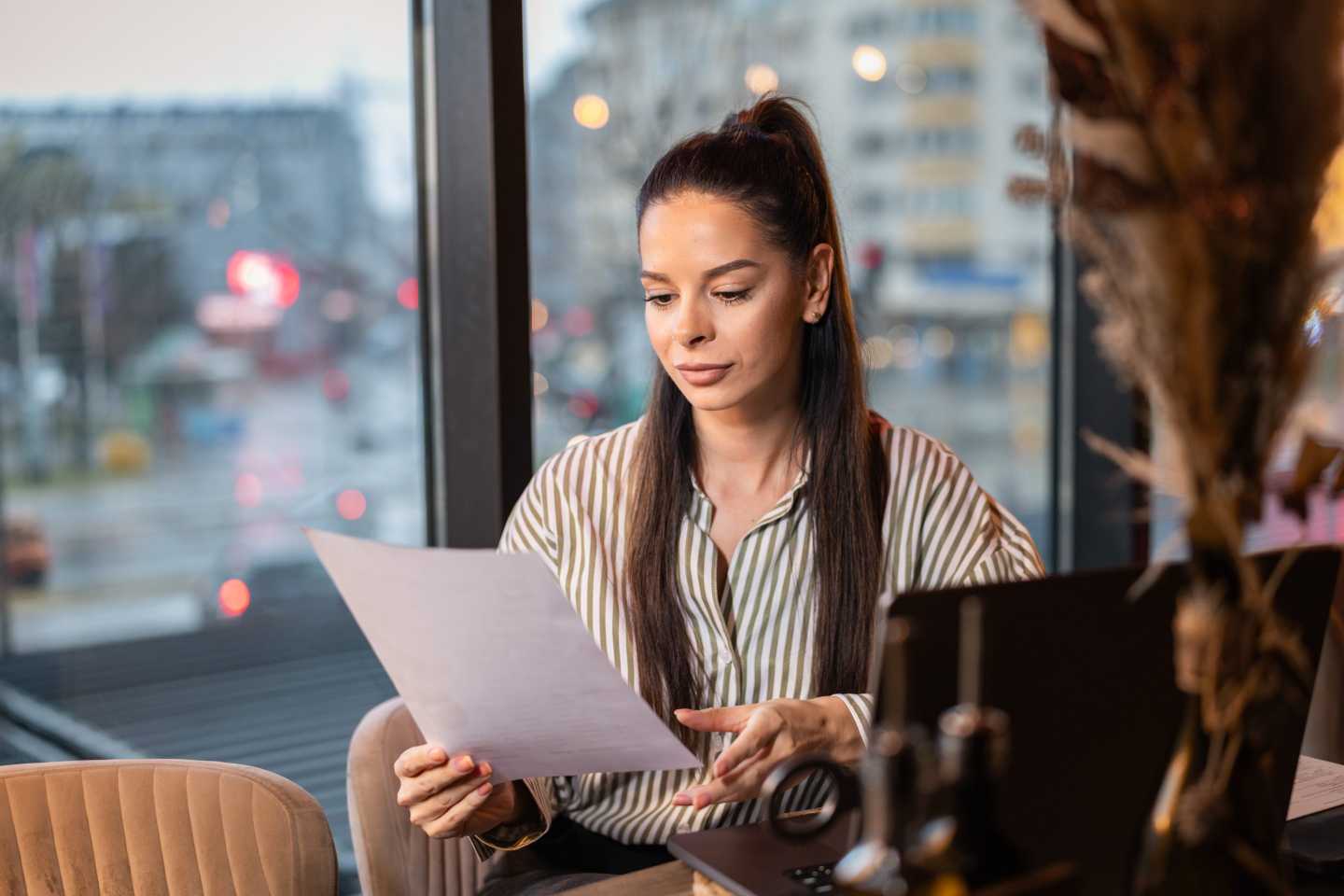 A person at a desk looking over a form.