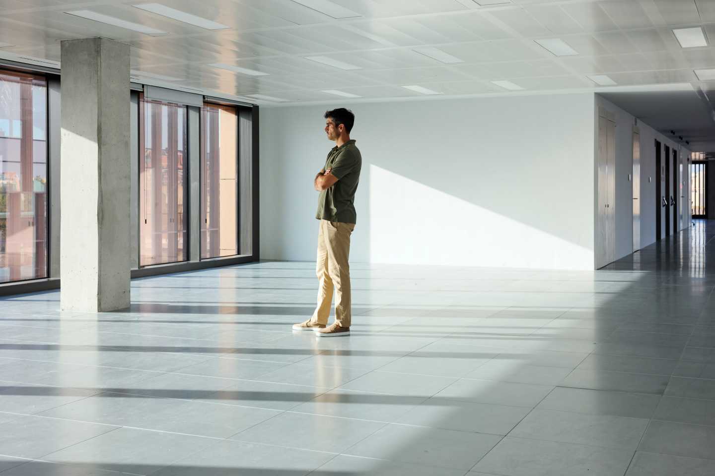 A person standing in an empty office space.