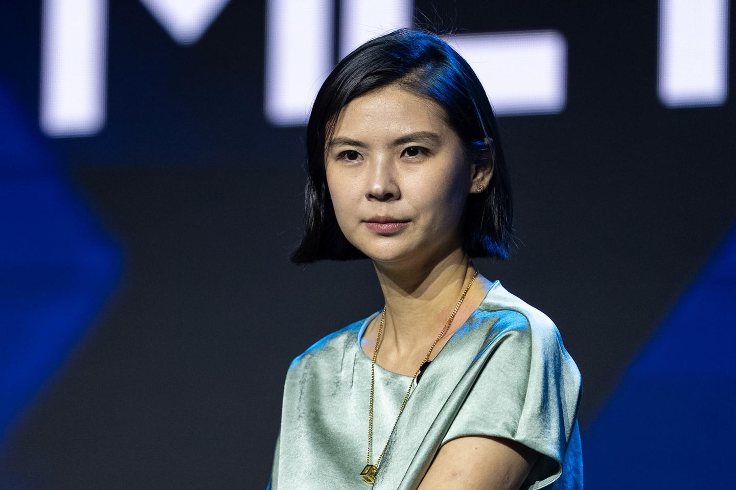 Bitget CEO Gracy Chen sits and looks off into the distance during a conference panel.