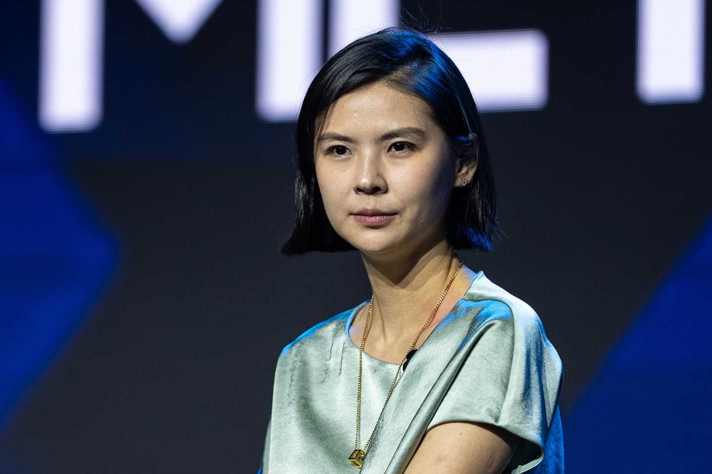 Bitget CEO Gracy Chen sits and looks off into the distance during a conference panel.
