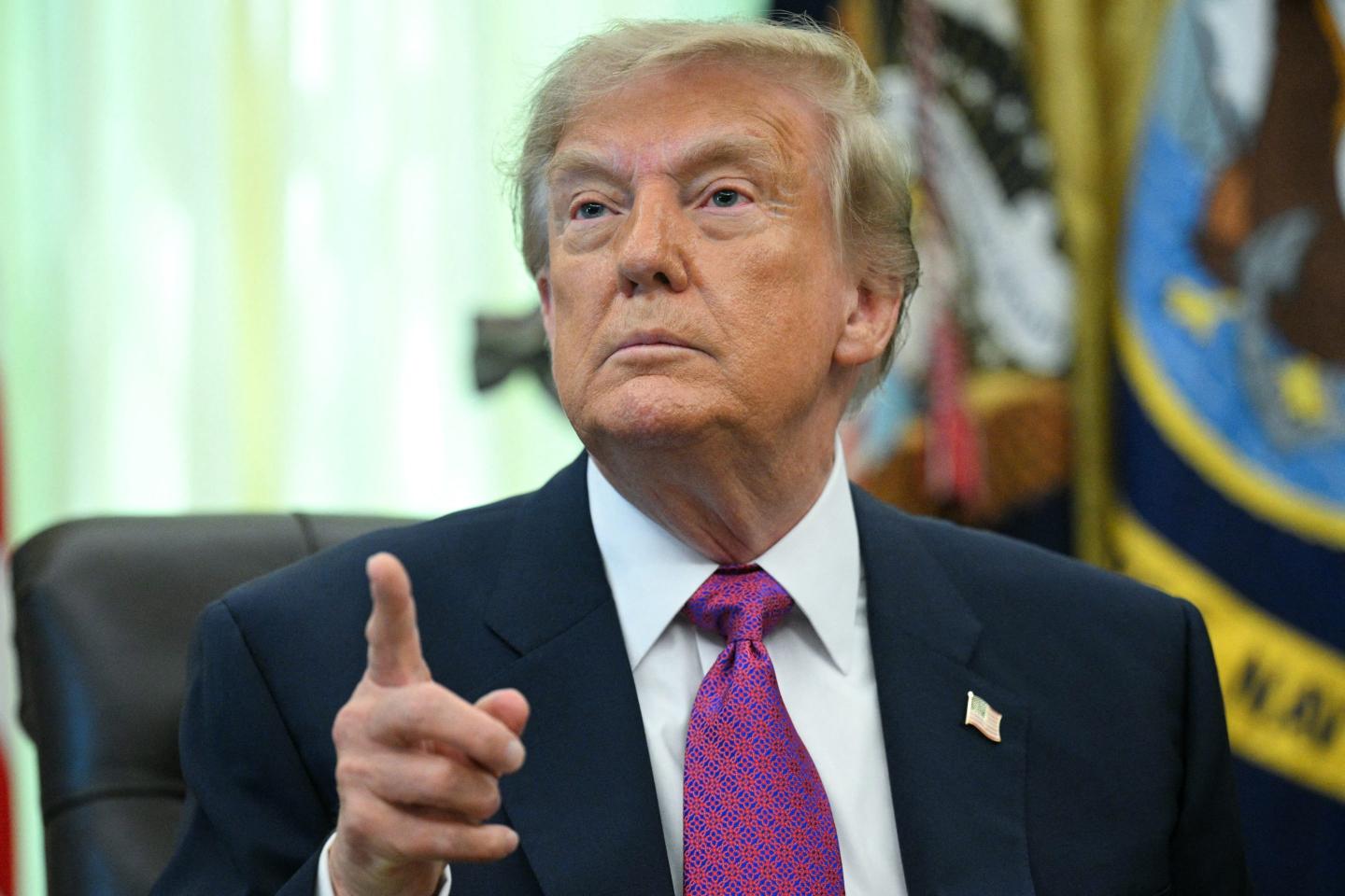 US President Donald Trump speaks after signing an executive order that aims to rename Lake Ontario to Lake America in the Oval Office of the White House in Washington, DC.