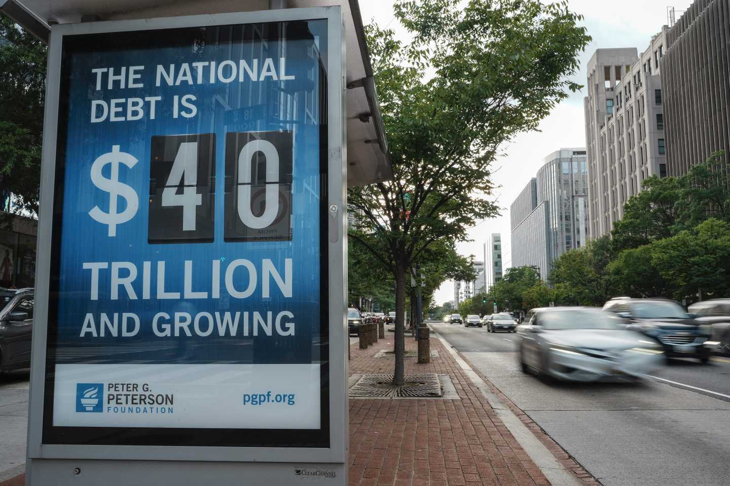 A view of a bus shelter at 18th and K St's NW where a poster and electronic billboard displays the current U.S. National debt per person and as a nation at 40 Trillion dollars on August 30, 2026 in Washington, DC.