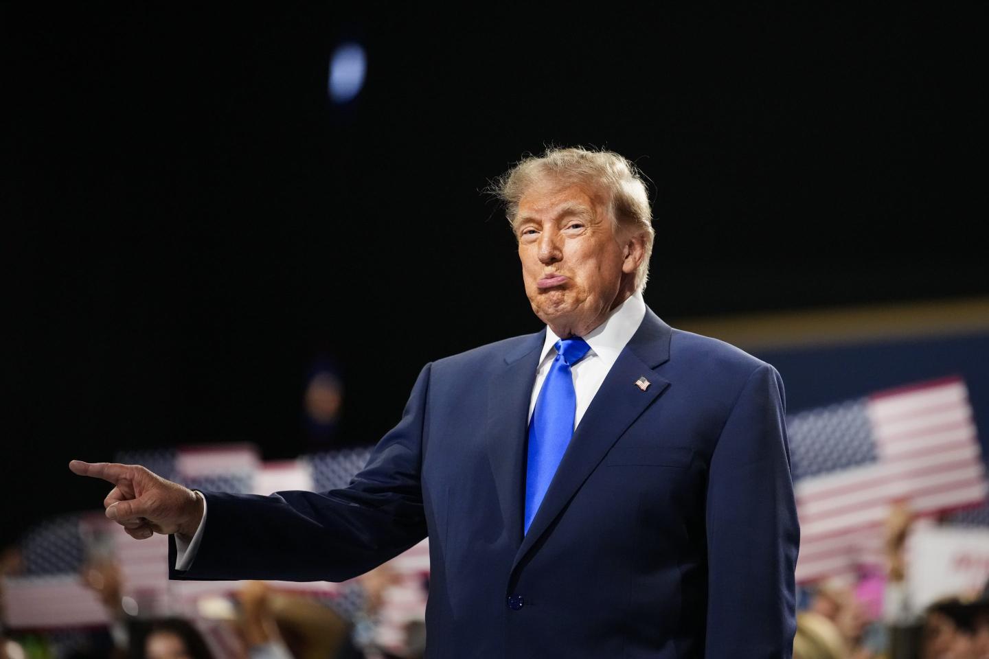 U.S. President Donald Trump walks on stage to speak on the first day of the 2026 Republican National Convention at the American Airlines Center.