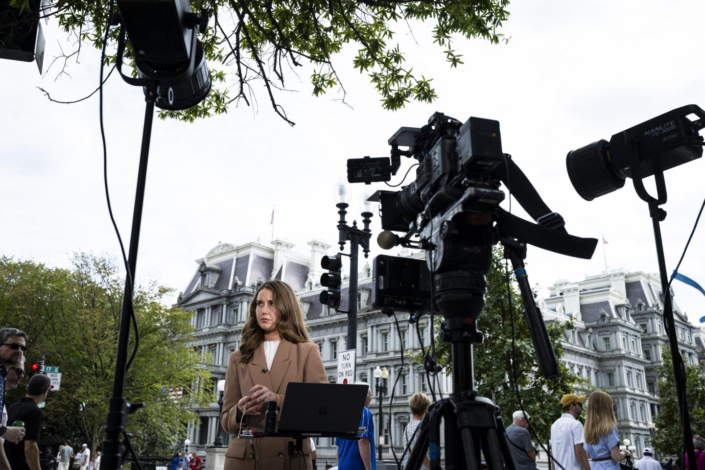 CNN correspondent Julia Benbrook prepares for a television report outside the White House grounds after earlier being denied entry, on Sept.19, 2026 in Washington, DC. 