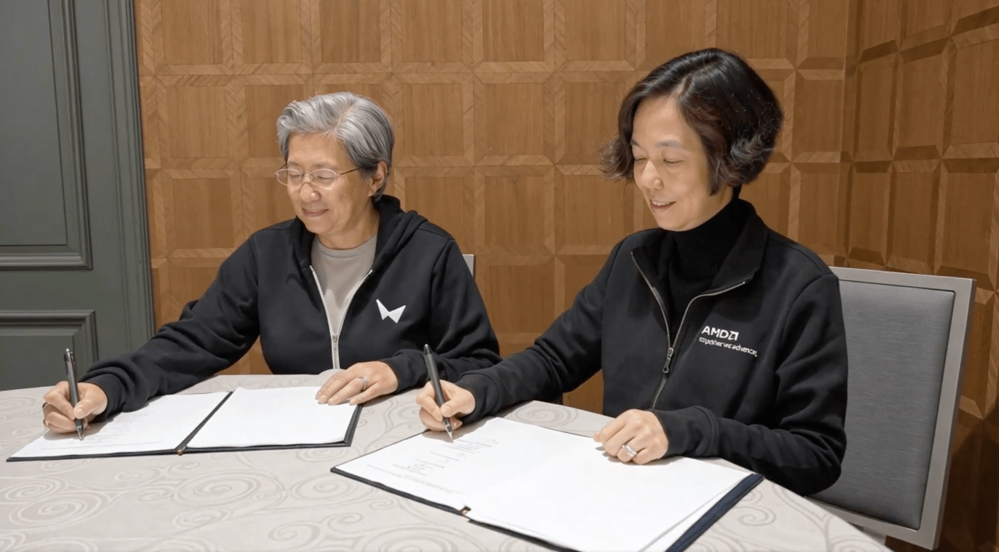 AMD CEO Lisa Su (left) and World Labs CEO Fei-Fei Li sign the   deal bringing the two companies together.