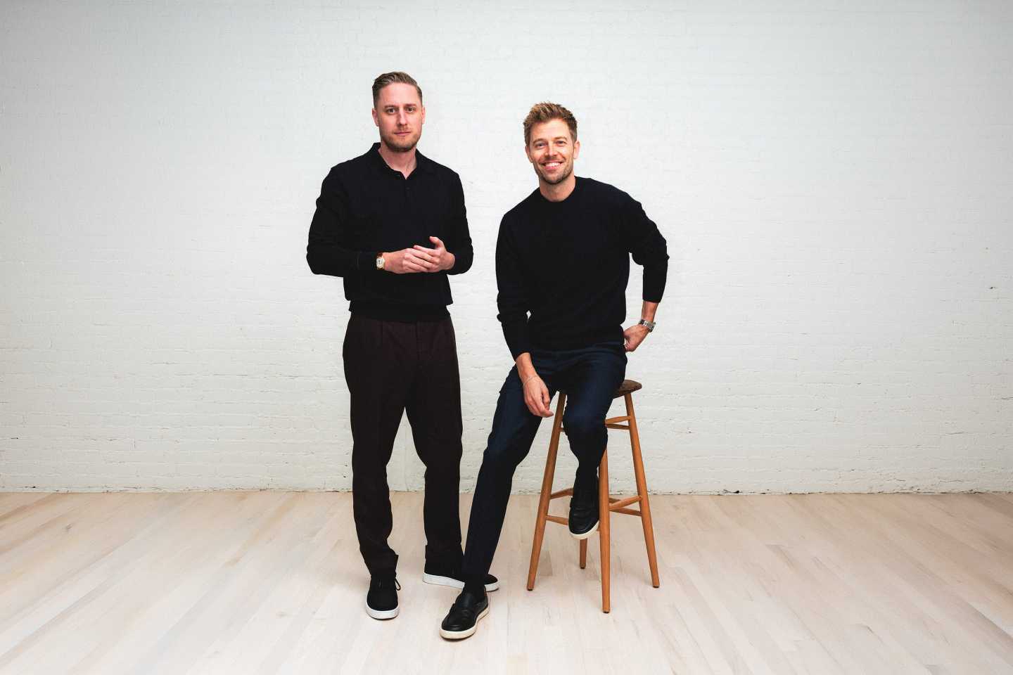 Public cofounder Leif Abraham (left) stands smiling at camera while Jannick Malling (right) does the same while sitting on a high stool.