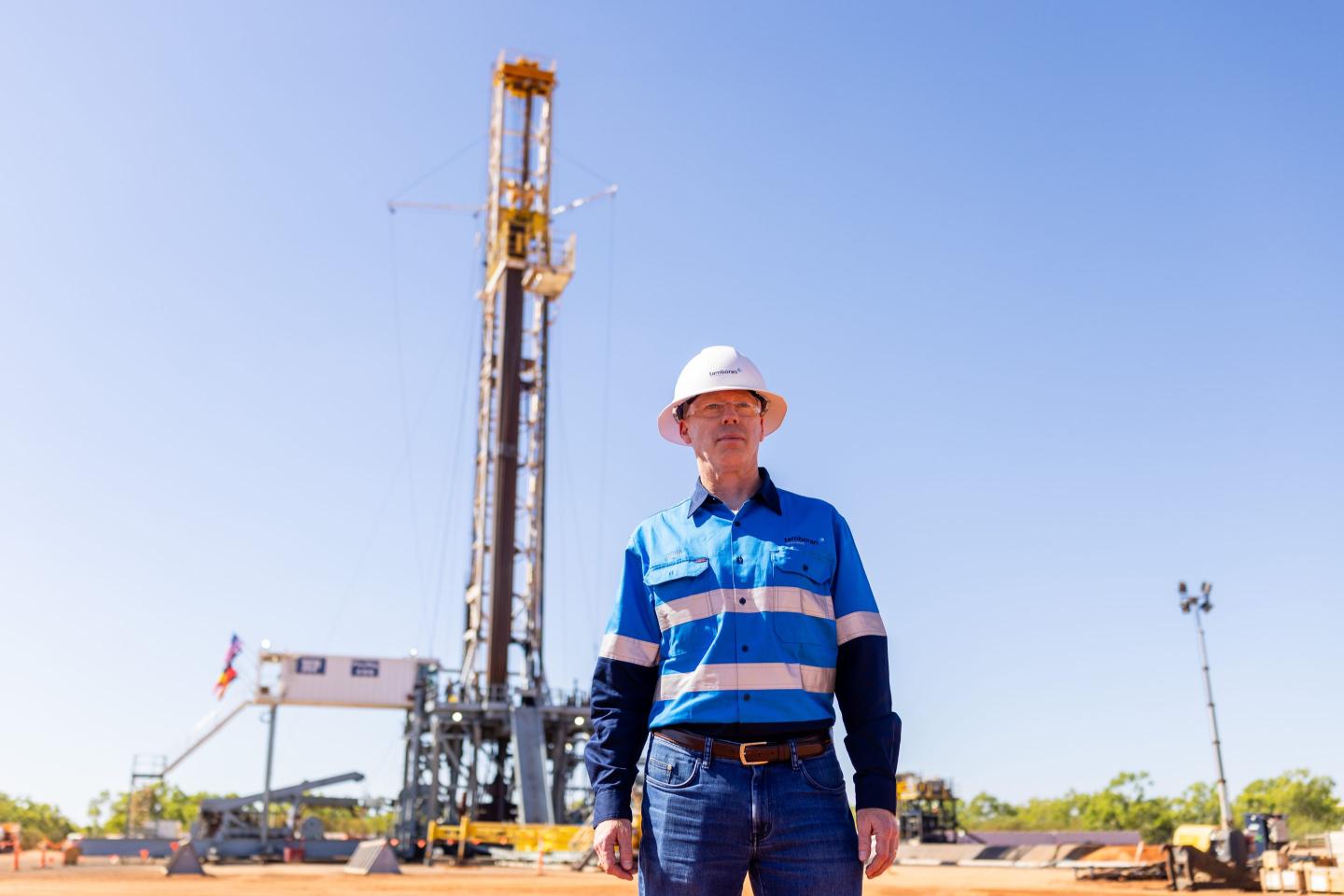 Tamboran Resources CEO stands in front of an H&P drilling rig shipped from the U.S. to Australia's Beetaloo Basin.