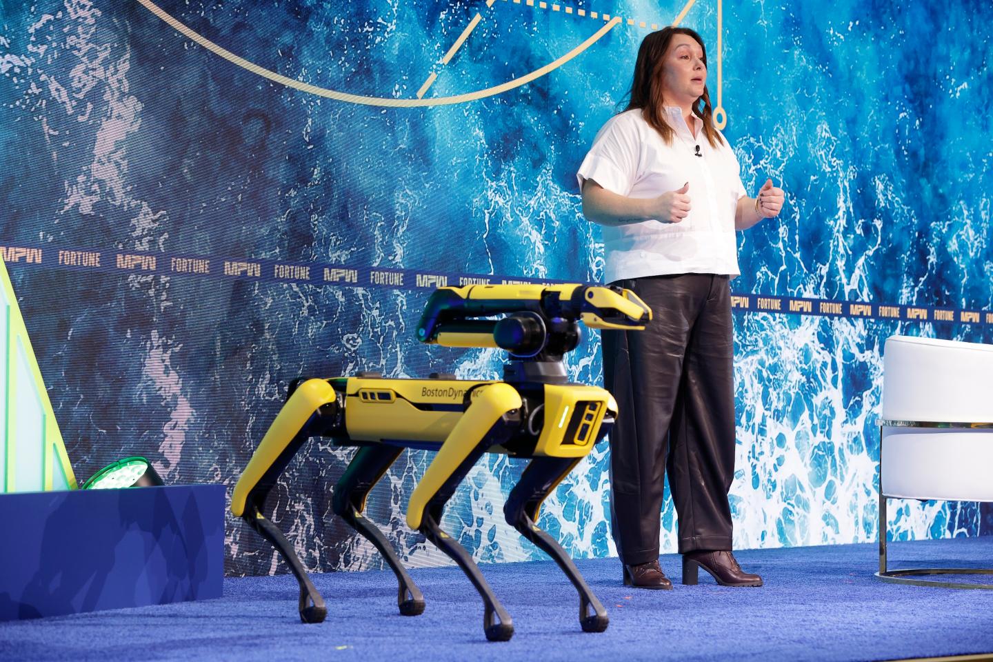 Amanda McMaster, CFO at Boston Dynamics, with Spot, the company's four-legged robot, at the 2026 Fortune Most Powerful Women Summit.