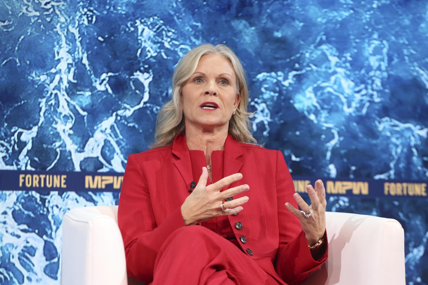 Woman in a red suit talking