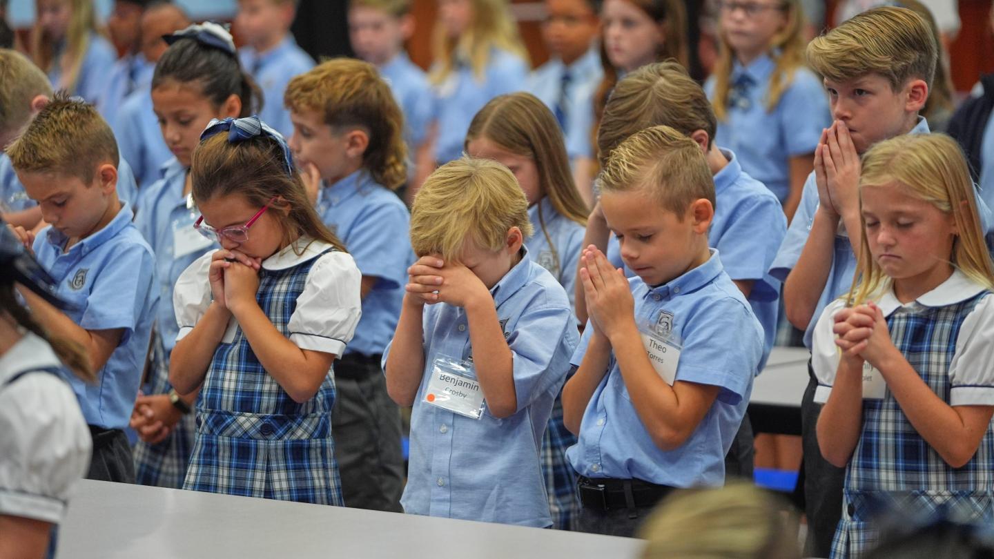 Children at Covenant Christian Academy pray during chapel at the private school in Colleyville, Texas.