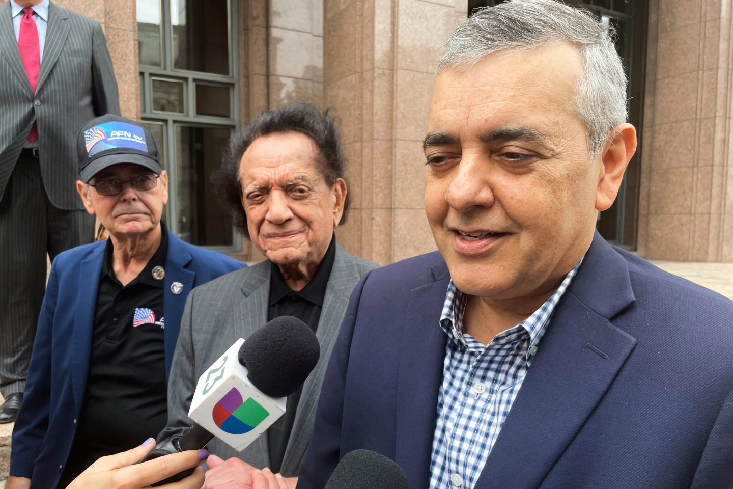 Former U.S. Rep. David Rivera speaks with media outside a federal court in Miami.