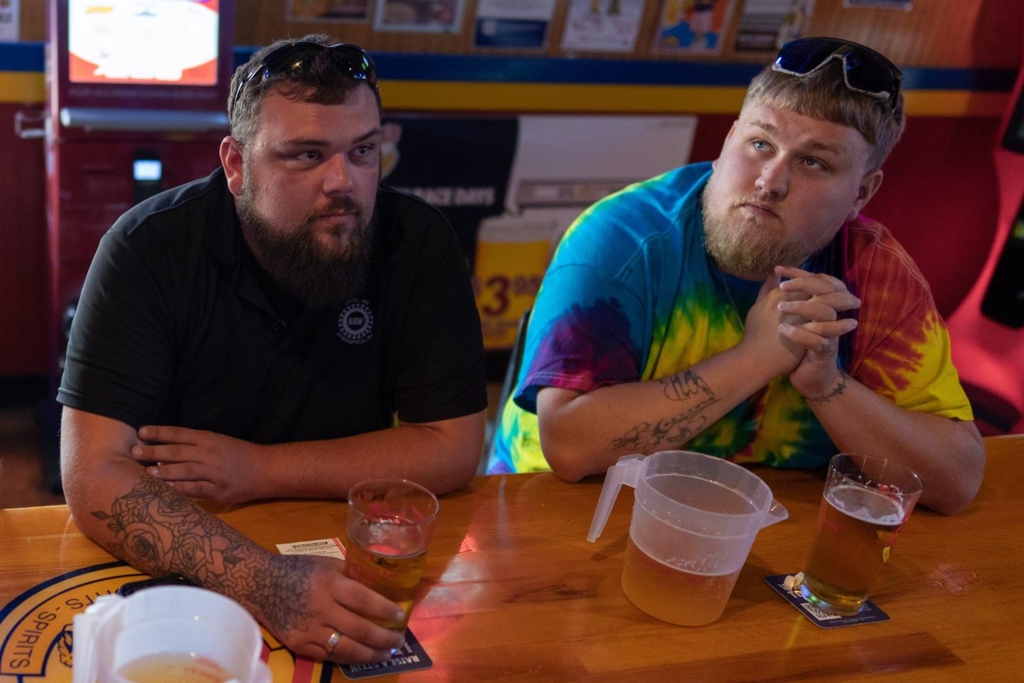 UAW Local 402 members Chaz Graham, left, and Kyle Bos, right, share a beer at Fricker's restaurant and bar in Springfield, Ohio, on Wednesday, Sept. 30, 2026.