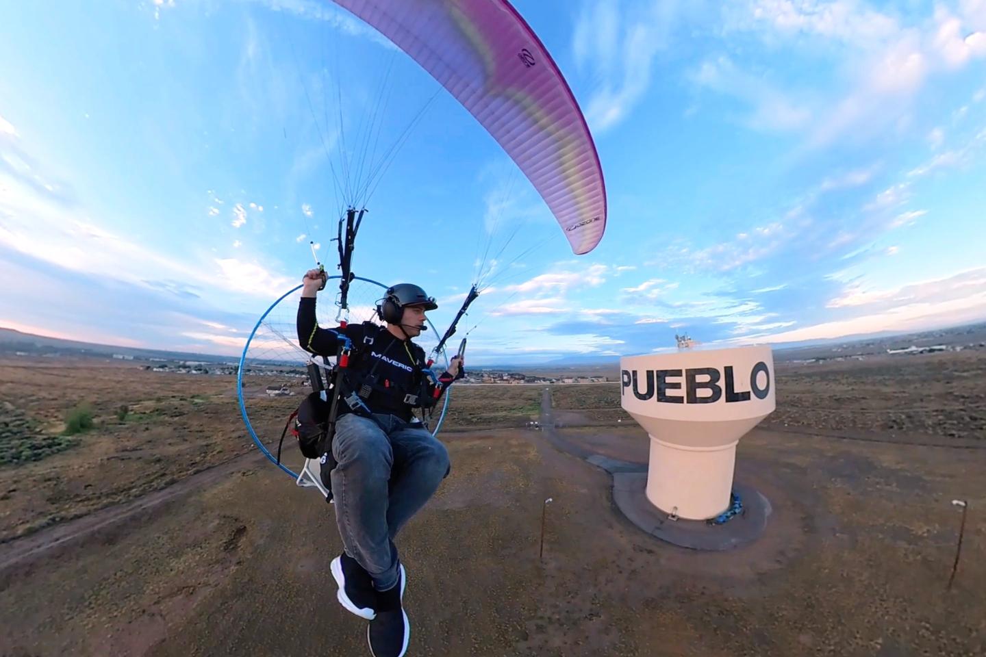 Jacob Hutzler flies his paramotor to work as an air traffic controller in Pueblo, Colo., on Aug. 13, 2026.