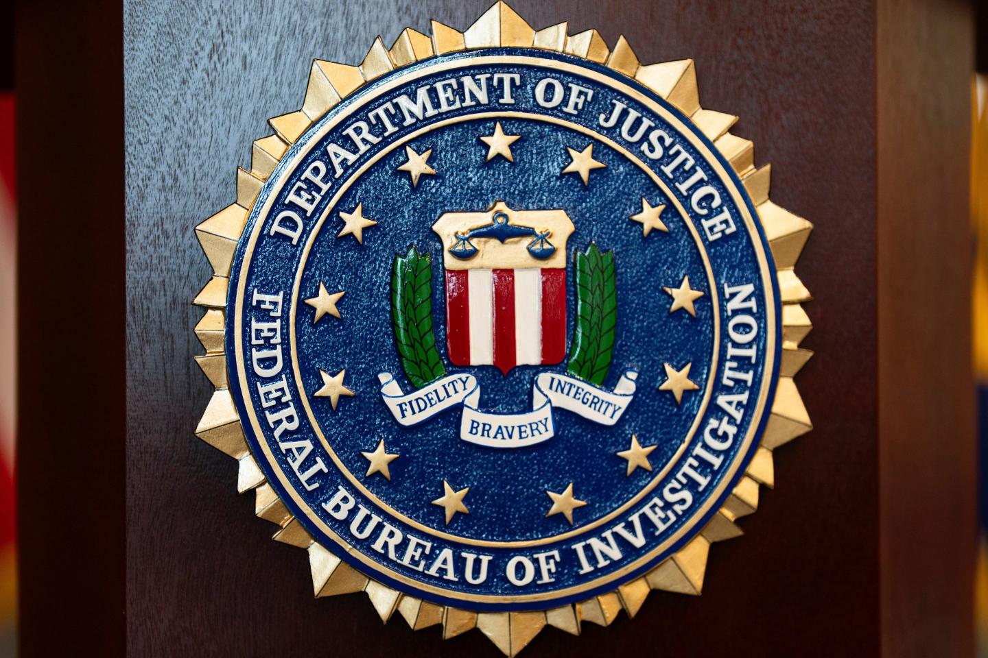 An FBI seal is displayed on a podium before a news conference at the field office in Portland, Ore.