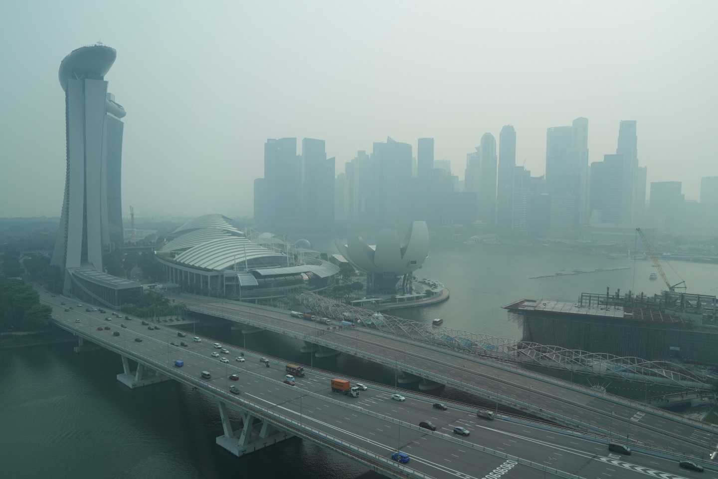 A thick haze obscures the skyline behind the Central Business District area in Singapore.