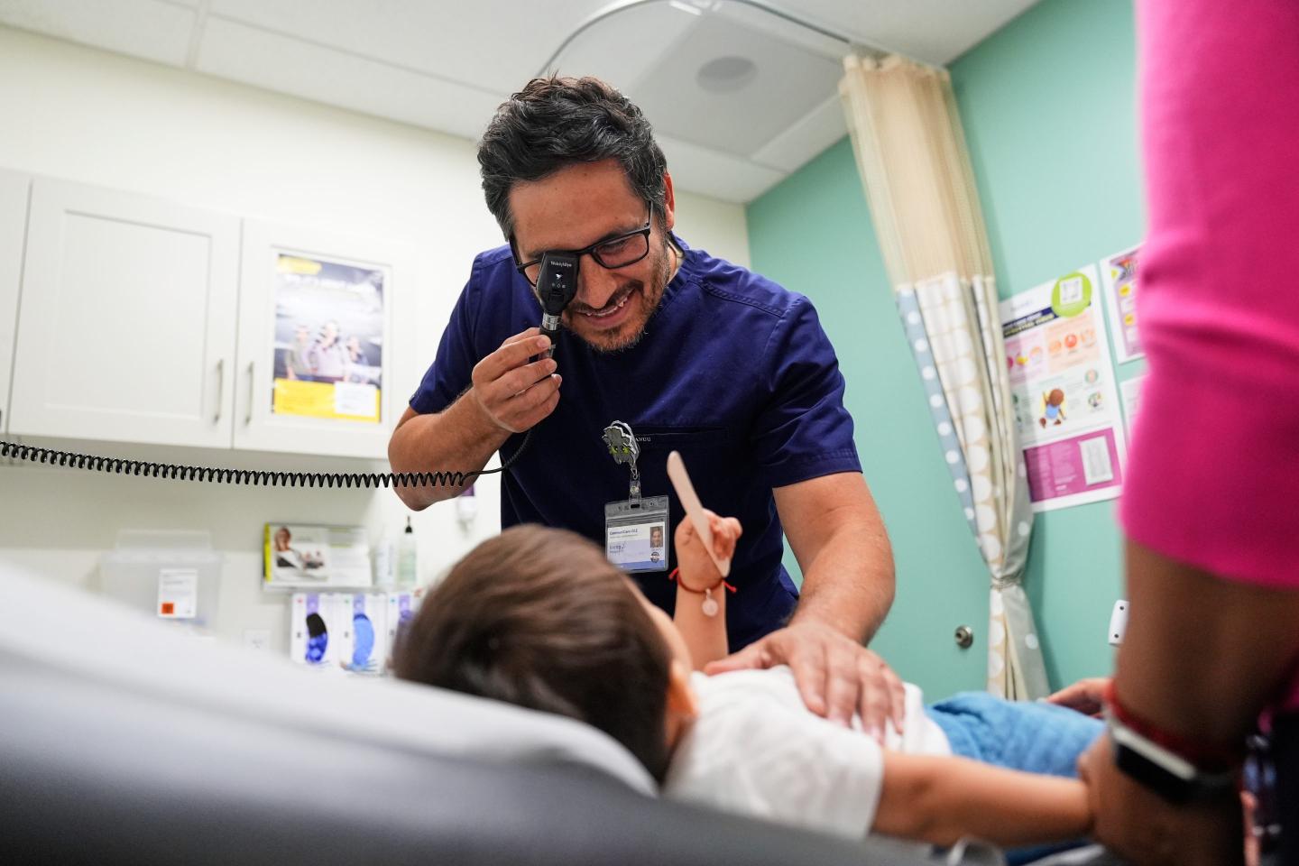 Pediatrician Irving Phillips examines a 16-month-old boy at a CommuniCARE+OLE clinic, June 26, 2025, in Davis, Calif. 