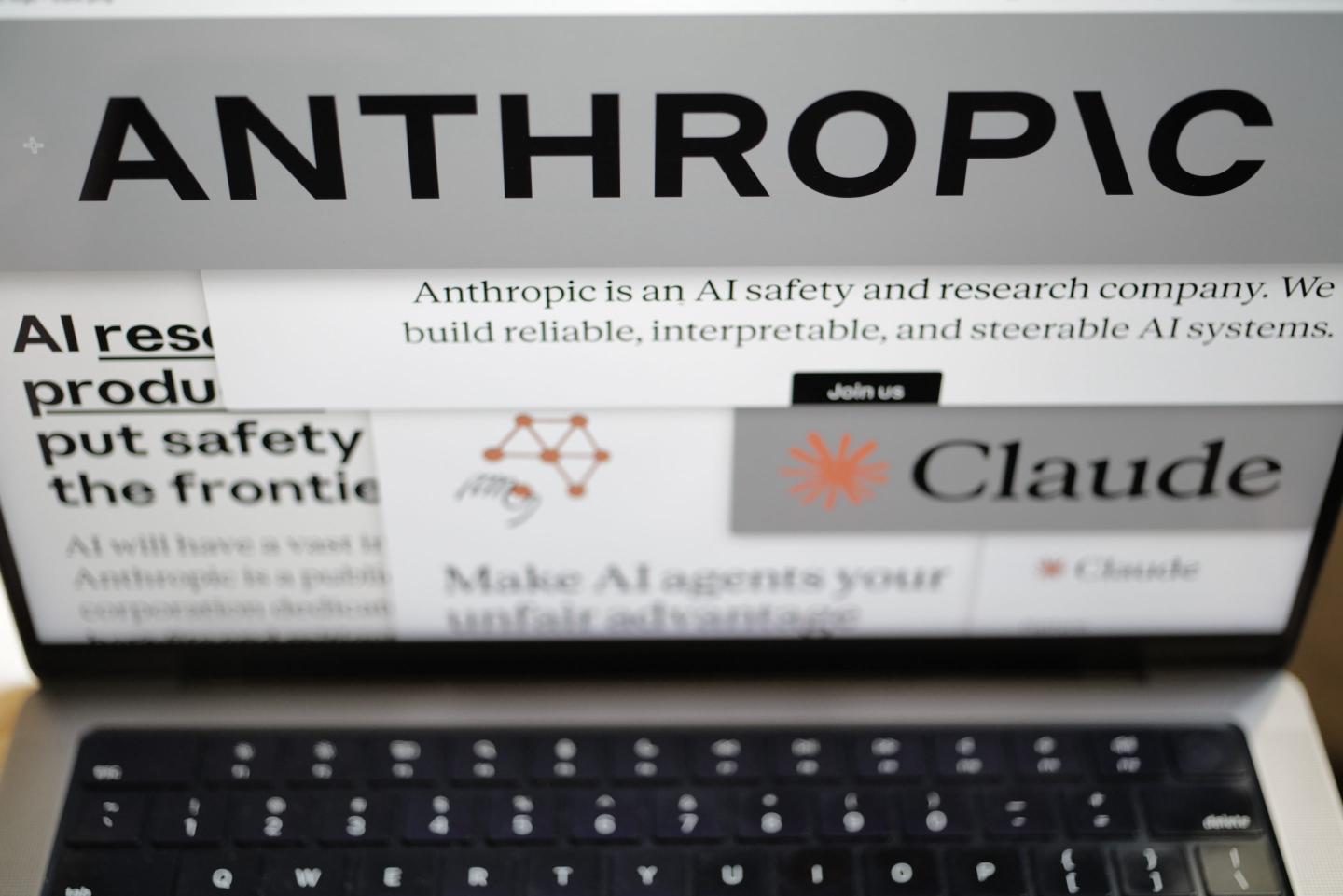 ages from the Anthropic website and the company's logos are displayed on a computer screen in New York on Thursday, Feb. 26, 2026.