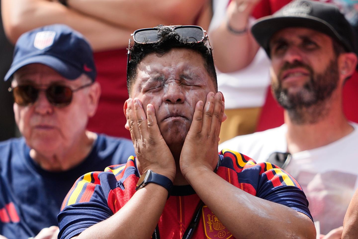 A fan puts on sunscreen prior to a World Cup match.