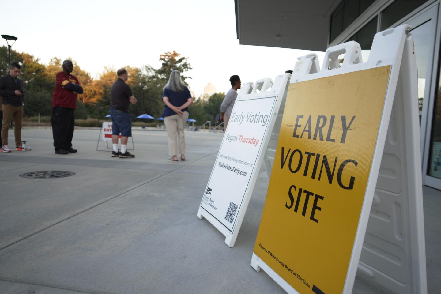 People line up outside the John Chavis Memorial Park center for the first day of early voting in Raleigh, N.C.