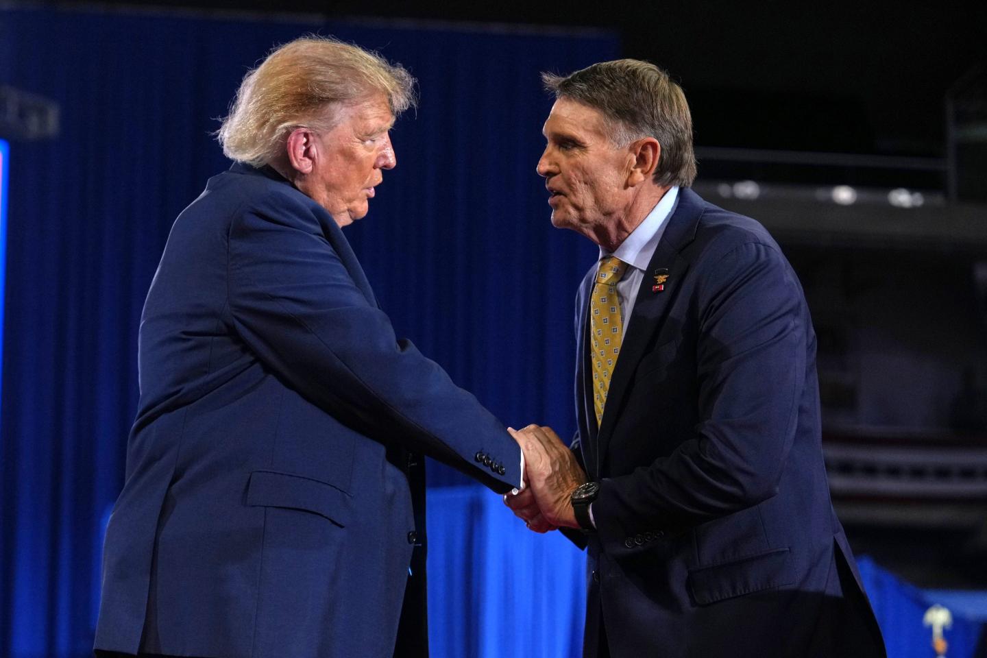 Kentucky Republican congressional candidate Ed Gallrein, right, shakes the hand of President Donald Trump at a campaign rally at Truist Arena at Northern Kentucky University, Saturday, Oct. 17, 2026, in Highland Heights, Ky.