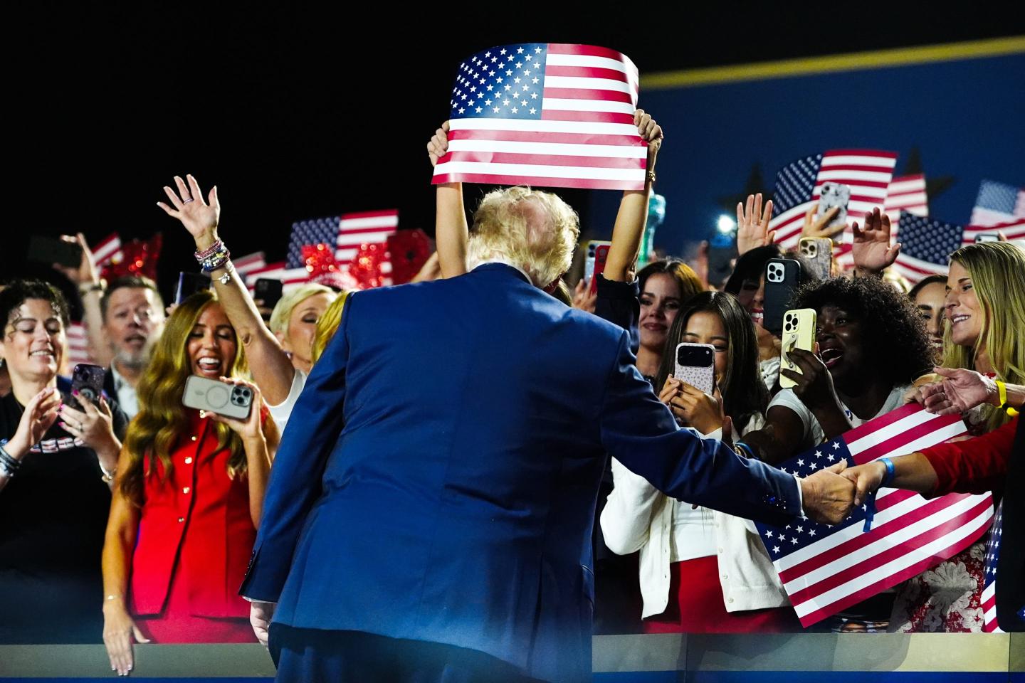 President Donald Trump greets supporters as he arrives to speak at the Republican convention.