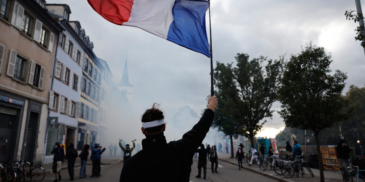 French police use tear gas and water cannons after some protests turn violent as shopkeepers board up storefronts across Paris