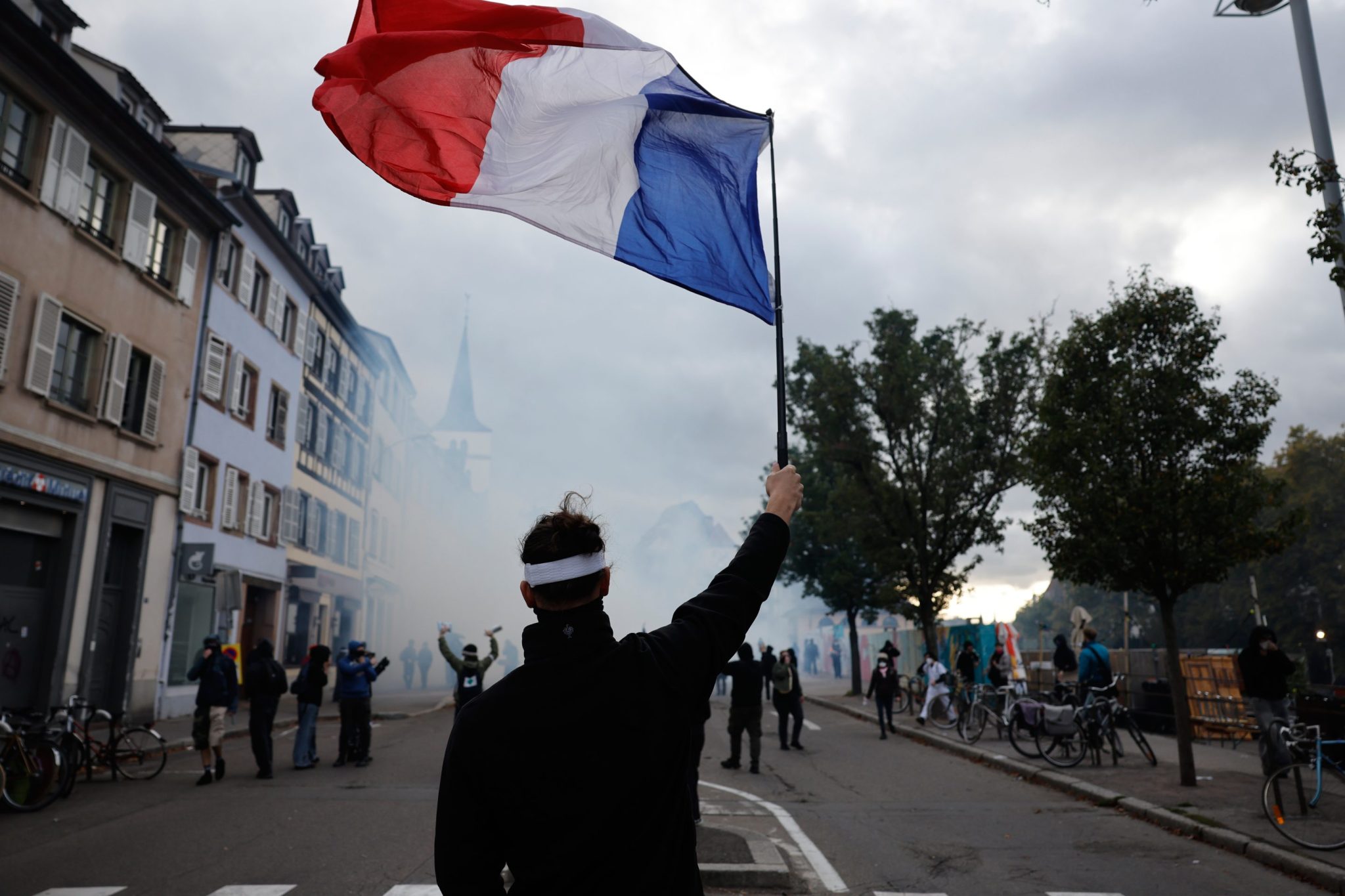 French police use tear gas and water cannons after some protests turn violent as shopkeepers board up storefronts across Paris