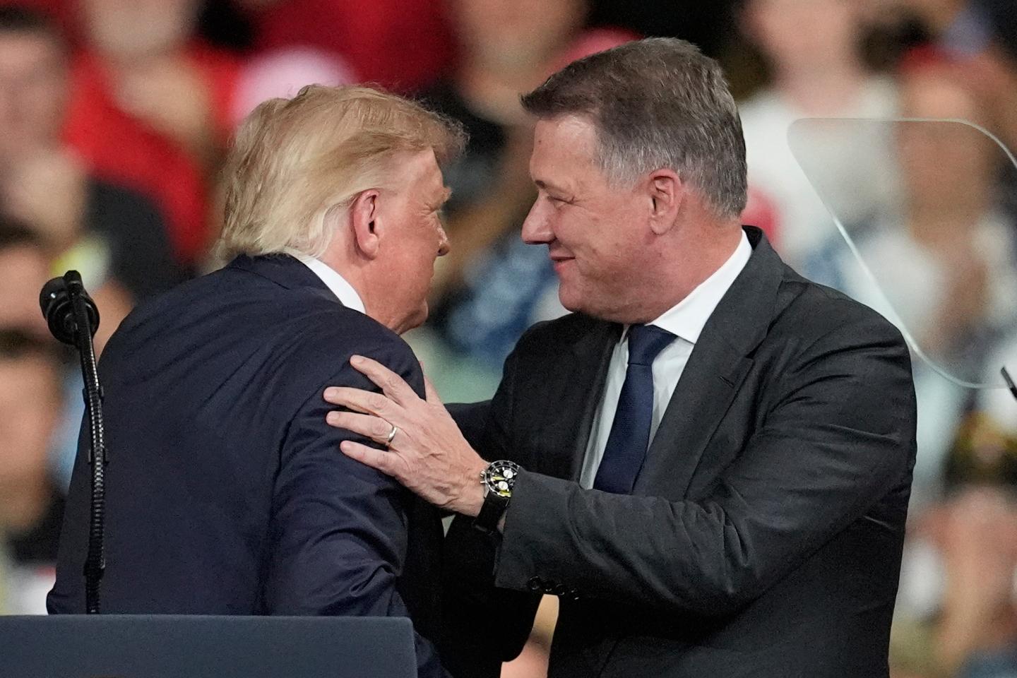 President Donald Trump greets Gernot Döllner, CEO of Audi AG, at a campaign rally at Guardian Centers of Georgia, Saturday, Oct. 24, 2026, in Perry, Ga.