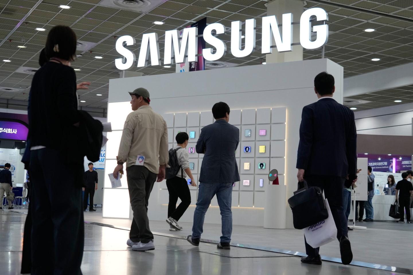 Visitors pass by the Samsung Electronics' booth during the Korea Electronics Show 2026 in Seoul, South Korea.