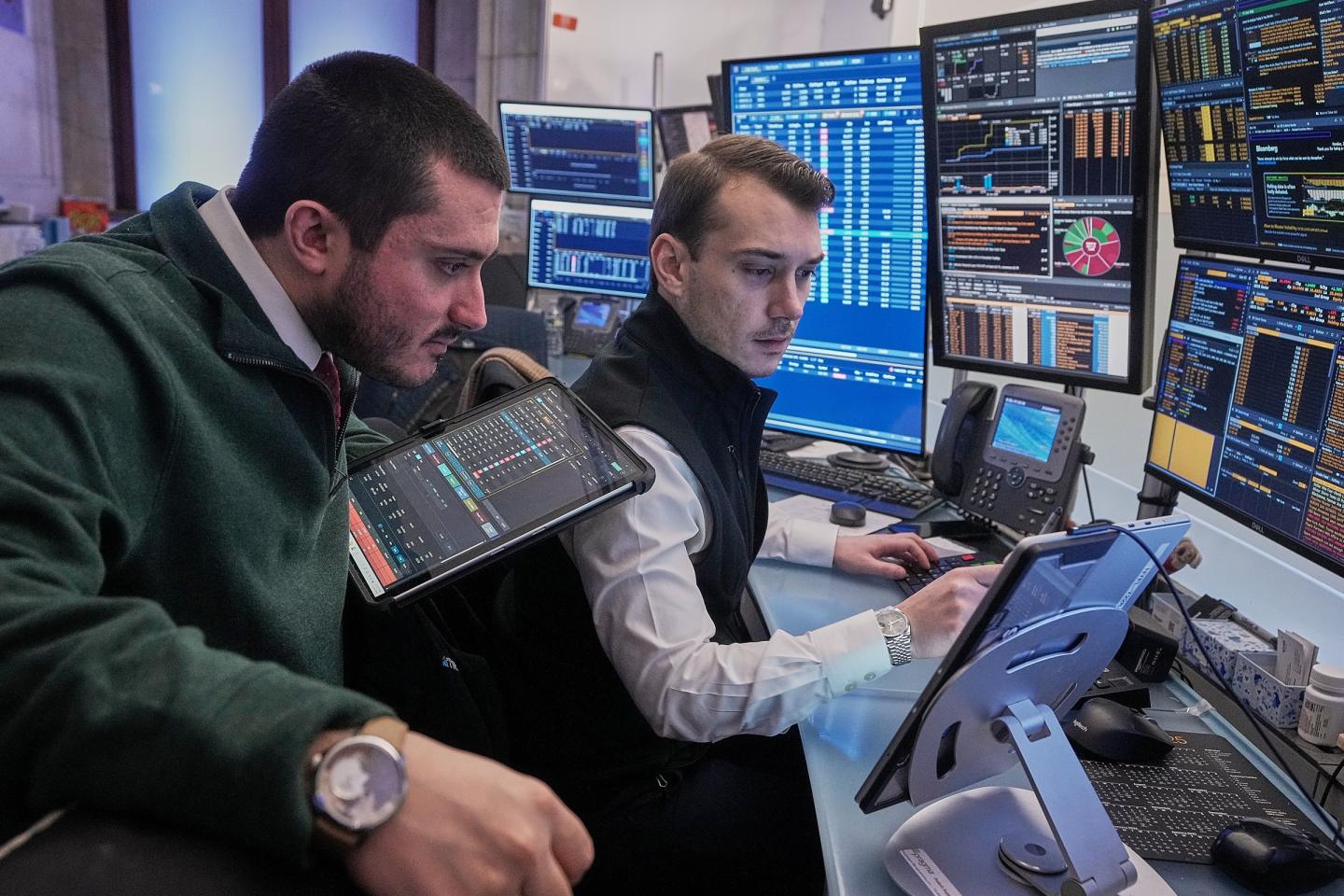 Traders work on the floor of the New York Stock Exchange