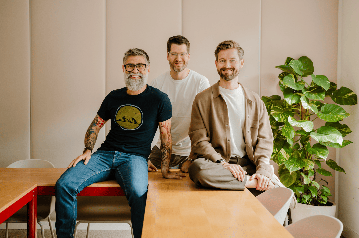 Maex Ament (left), Philip Stanislaus (middle), and Henrik Gebbing) sit smiling at the camera.