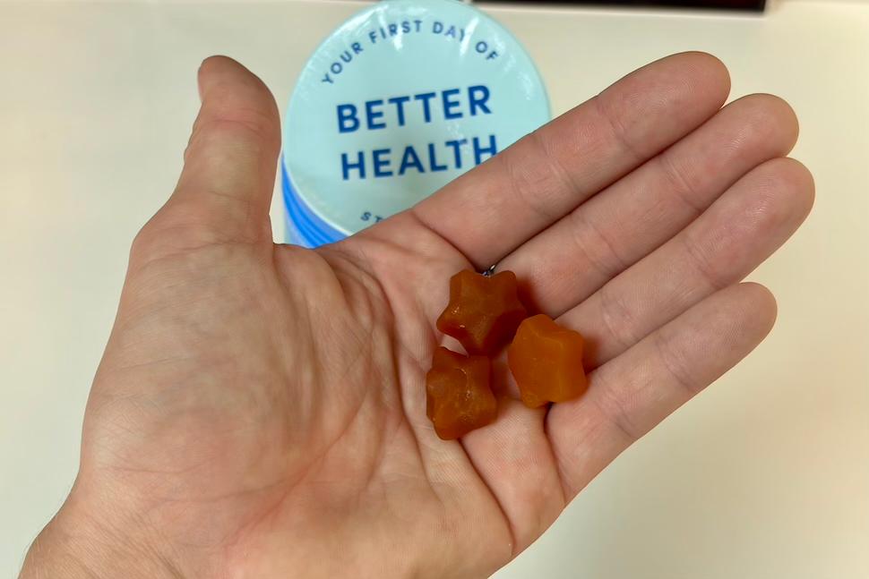 Closeup of an open palm holding three First Day Kids the Multi gummies