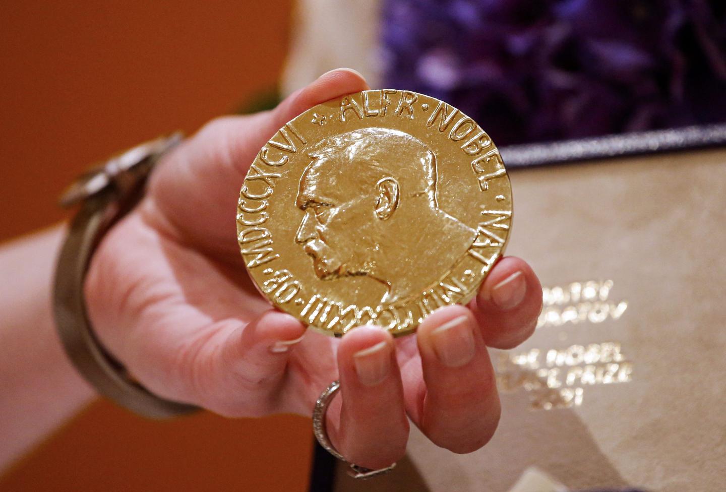 A woman holds Russian journalist Dmitry Muratov's 2021 Nobel Peace Prize medal in New York, on June 20, 2022. Muratov is the editor-in-chief of the Russian newspaper Novaya Gazeta.