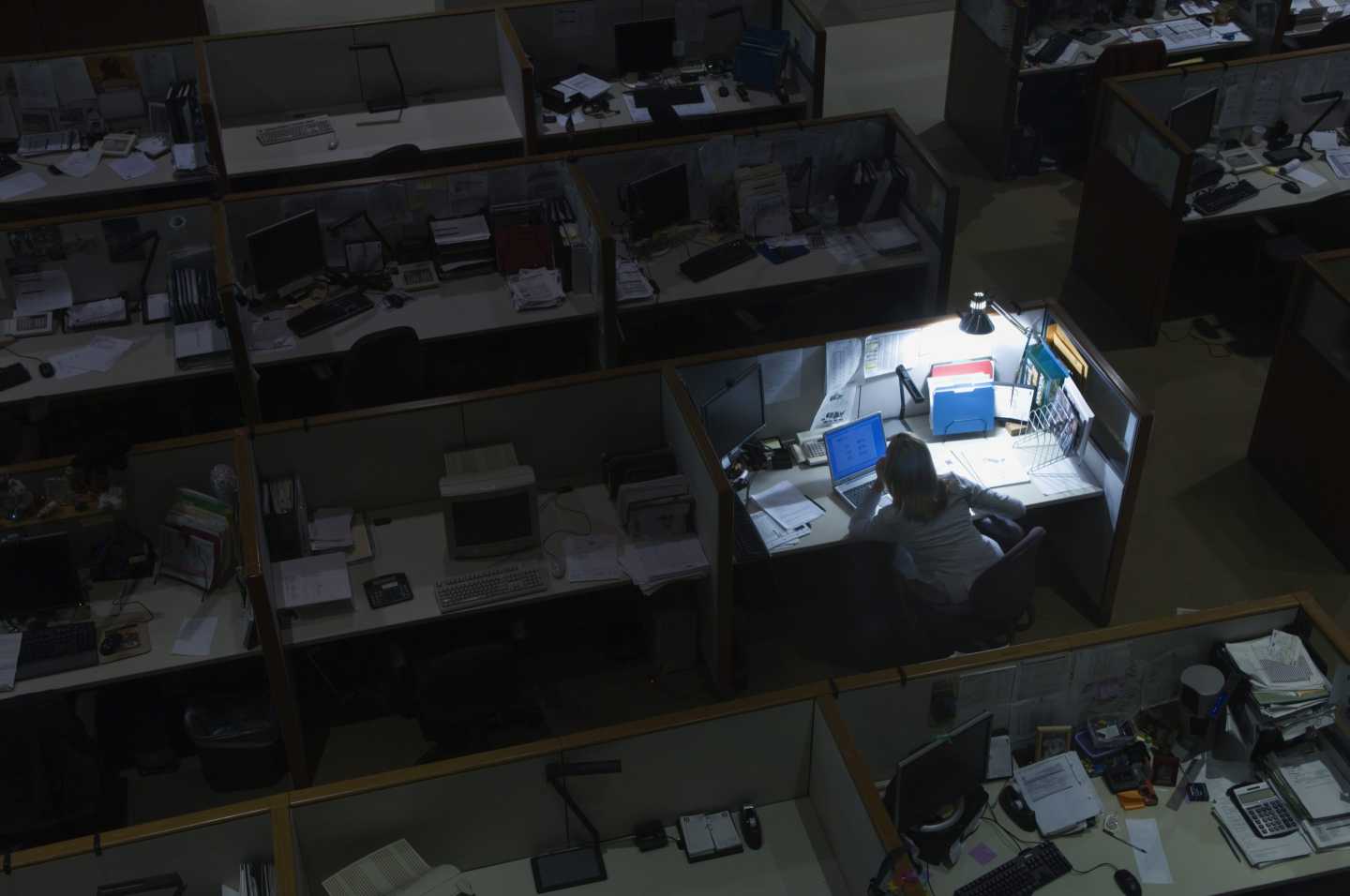 Woman working late at night in office.