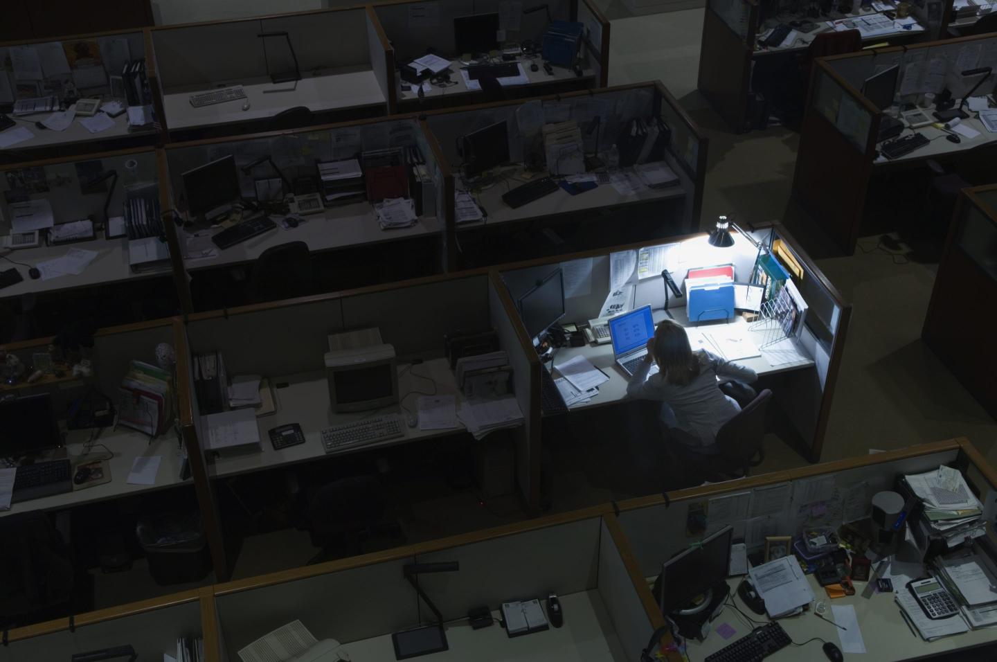 Woman working late at night in office.