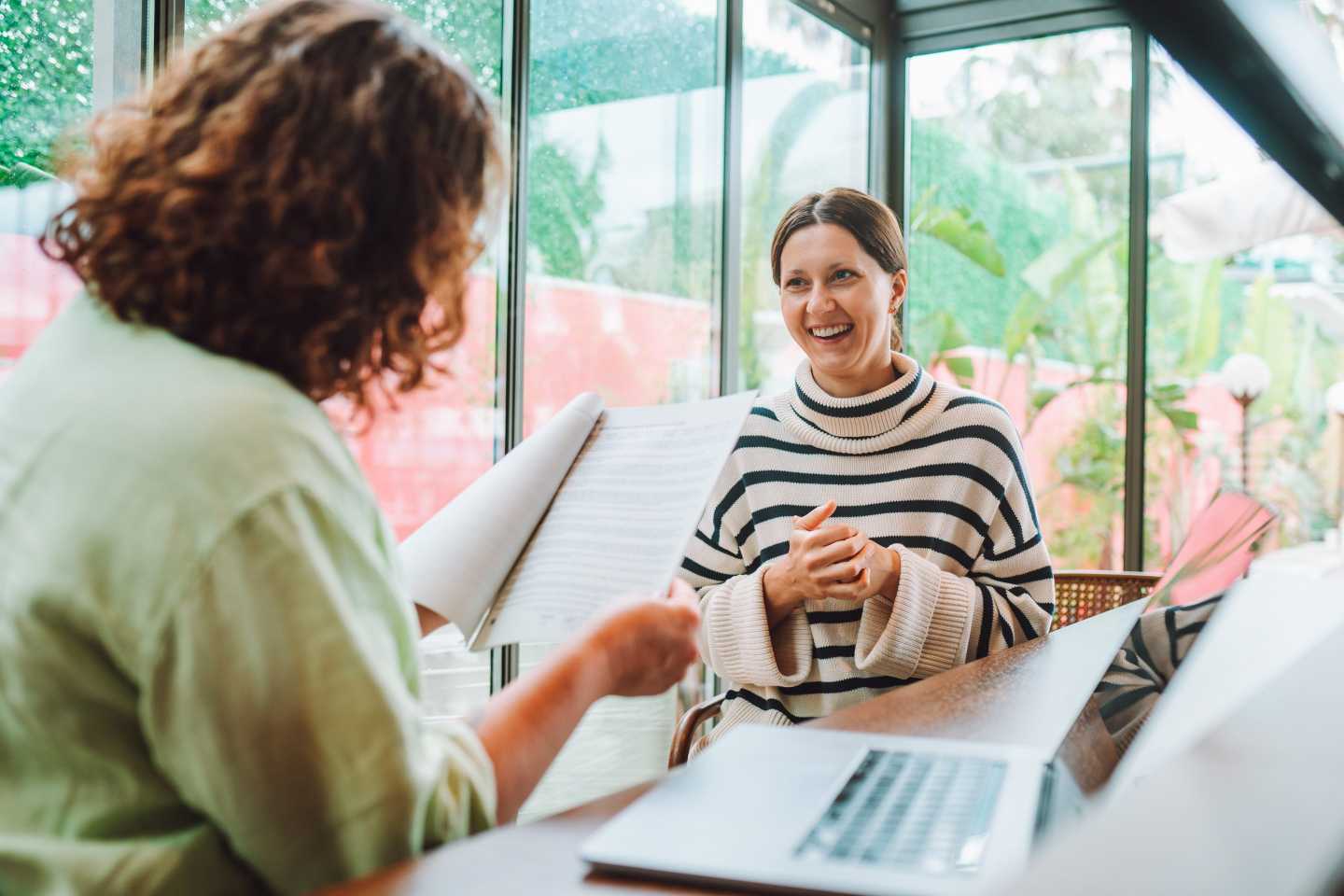 Woman manager interviews a job candidate using laptop to evaluate job seeker qualifications