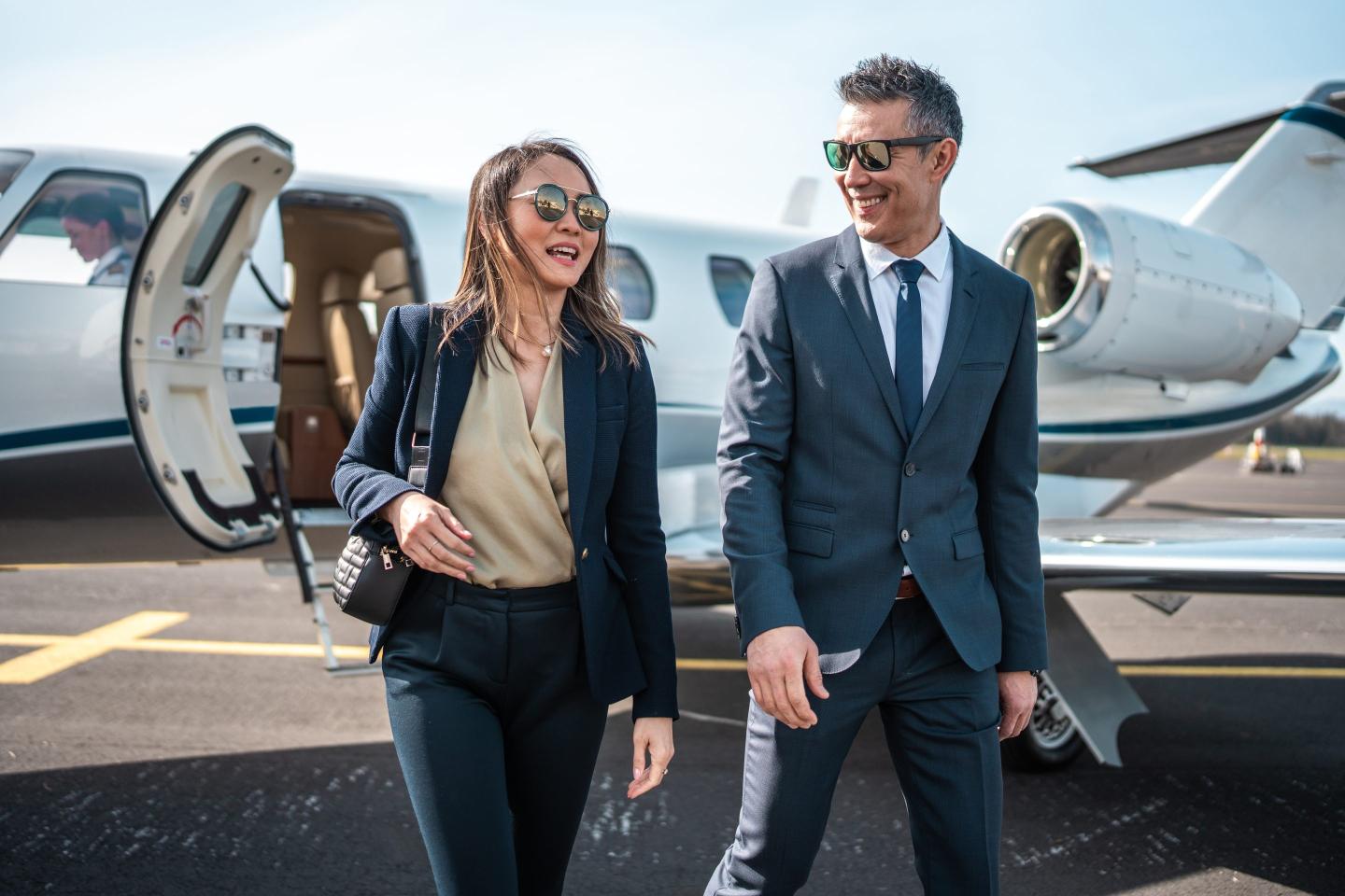 Rich people getting off of private jet