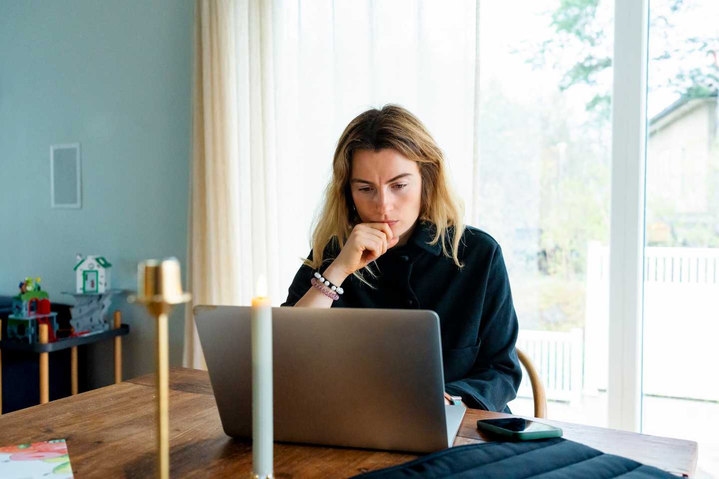 Woman at home looking at her laptop screen
